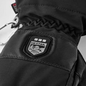 Black Hestra glove with branded rubber patch and carabiner