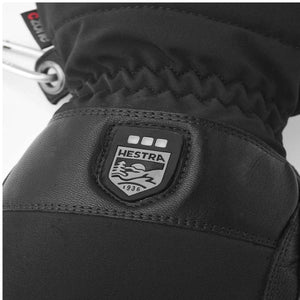 Black Hestra glove with embossed brand logo patch and CZone label