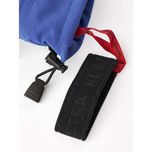 Blue Hestra glove cuff with black drawstring toggle and black wrist strap