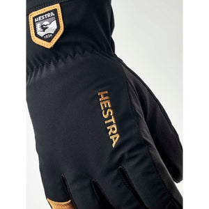 Black Hestra glove with embroidered logo and leather brand patch