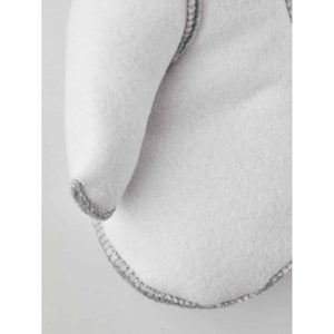 Close up of Hestra white wool mitten fabric with grey stitched seams