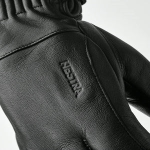 Black Hestra leather glove with embossed logo