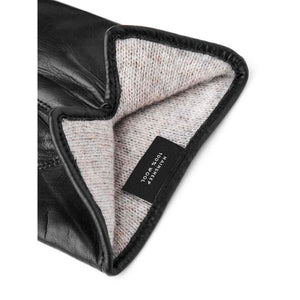 Hestra black leather glove interior with wool lining and material tag