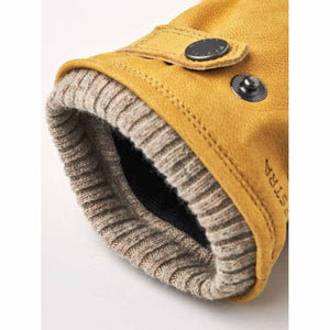 Hestra yellow leather glove cuff with ribbed knit lining and snap button closure