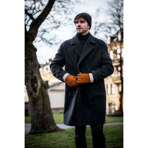 Man wearing Hestra tan suede gloves with wool lining and a dark wool coat