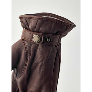 Brown leather Hestra glove with a snap button wrist strap