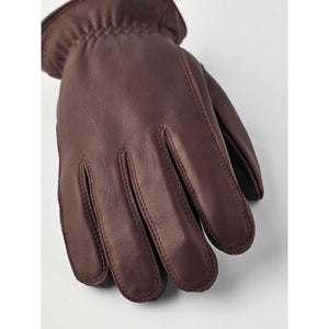 Hestra brown leather glove on white background