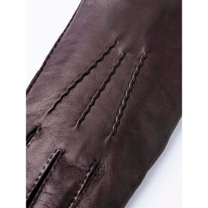 Close up of dark brown Hestra leather glove with decorative stitching on the back