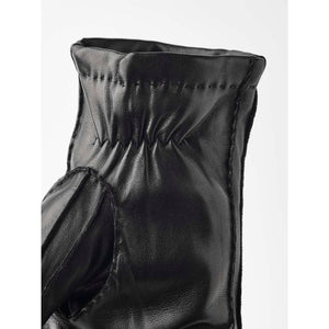 Close up of black Hestra leather glove cuff with elastic detail