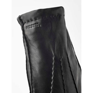 Black Hestra leather glove cuff with embossed logo