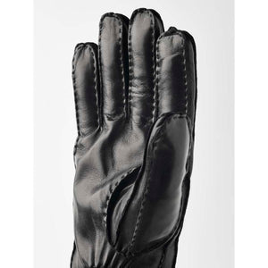 Black leather glove with visible exterior stitching