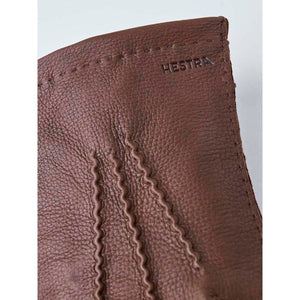 Brown Hestra leather glove detail with visible stitching
