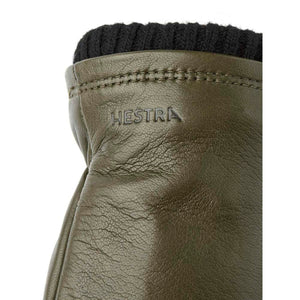 Olive green Hestra leather glove with black ribbed cuff