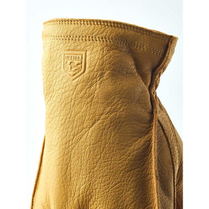 Tan Hestra leather glove cuff with embossed logo
