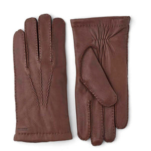 Hestra brown leather gloves with decorative stitching on the back