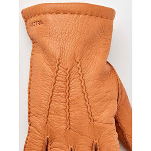 Tan Hestra leather glove with decorative stitching on the back