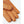 Tan leather driving gloves with perforated detailing on a white background