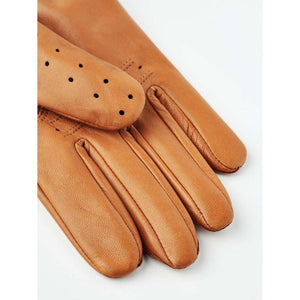 Tan leather driving gloves with perforated detailing on a white background