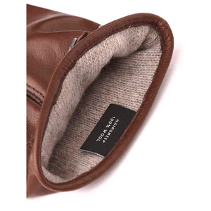 Interior of Hestra brown leather glove with wool lining and material label