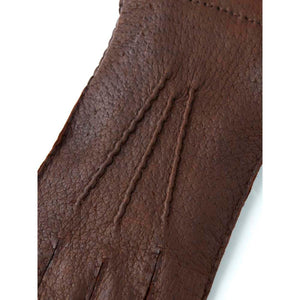 Close up of brown Hestra leather glove with decorative stitching