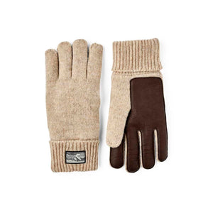 Beige knit Hestra gloves with brown leather palms and ribbed cuffs