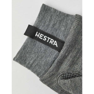 Grey Hestra glove cuff with branded black fabric tab