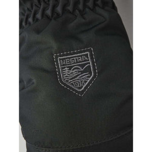 Hestra brand logo patch on black fabric