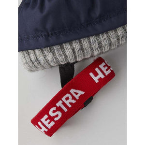 Hestra glove cuff with grey ribbed knit and red branded pull tab