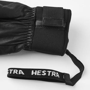 Black leather Hestra glove cuff with adjustable velcro strap and branded wrist tether