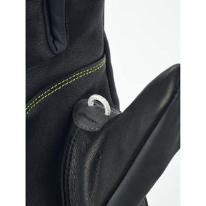 Close up of Hestra black leather glove with yellow stitching and white pull loop