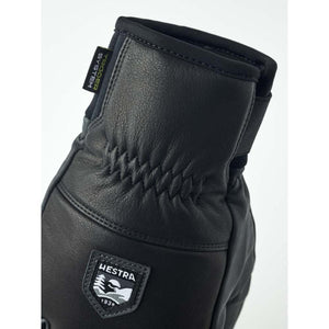 Black Hestra leather glove with elasticated wrist and trigger system label