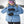 Person wearing Hestra black leather ski gloves with a blue jacket and ski helmet