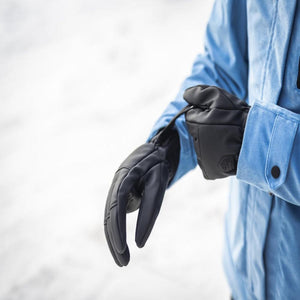 Person wearing Hestra black gloves with a blue jacket