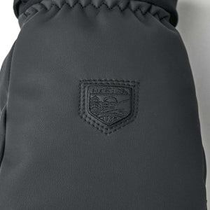 Black Hestra mitten with embossed brand logo patch
