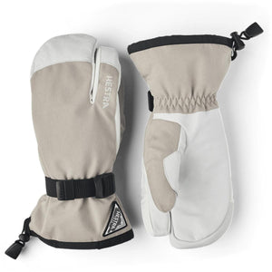 Hestra beige and white three finger ski mittens with black wrist straps and adjustable cuffs