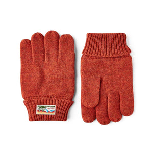 Hestra rust orange knit wool gloves with ribbed cuffs and branded patch