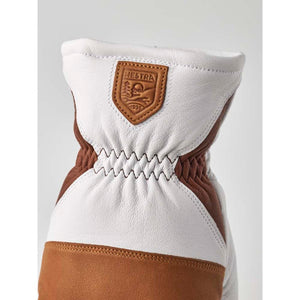 White and brown leather Hestra glove cuff with embossed logo patch