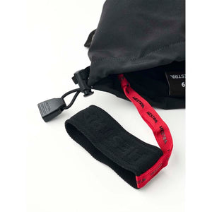 Hestra black glove cuff with red branded pull tab and adjustable drawstring