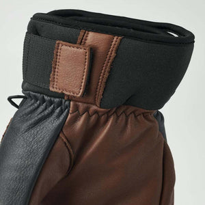 Brown and black leather glove cuff with velcro strap