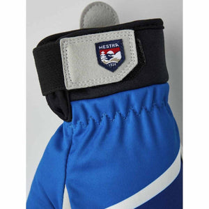Blue Hestra glove cuff with adjustable velcro strap and brand logo patch
