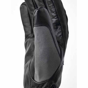 Black leather glove with grey fabric thumb patch