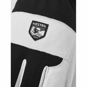Hestra glove with white leather and black fabric featuring a Hestra brand patch