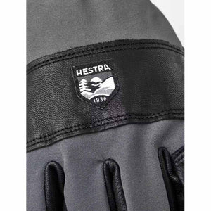 Hestra glove featuring a black leather patch with the Hestra brand logo