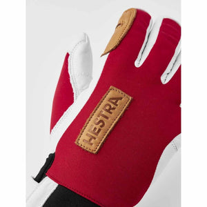 Hestra red and white leather glove with brown logo patch