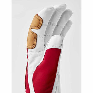 Hestra white leather glove with red fabric panel and tan knuckle reinforcement