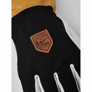 Close up of Hestra glove with leather cuff and branded patch