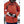 Skier wearing a red jacket and black and white Hestra gloves adjusting a backpack strap