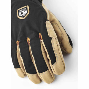 Hestra black and tan leather glove with brand logo patch
