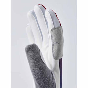 Hestra white ski glove with grey suede palm patch and red accents
