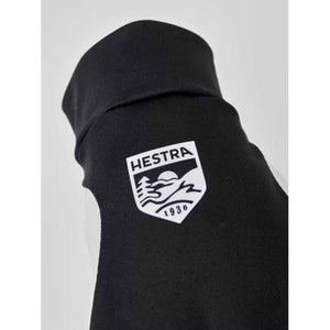 Black Hestra glove cuff with white brand logo patch